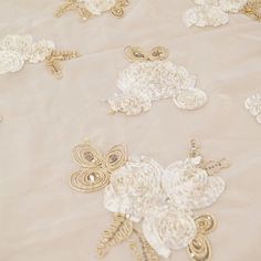 white and gold brooches on a table cloth