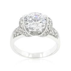 an oval cut diamond engagement ring with filigrees on the shoulders and sides