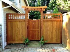 a wooden gate in front of a house