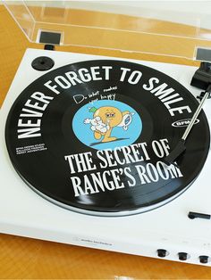 a record player with the words never forget to smile on it