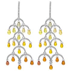 A delightful pair of chandelier earrings showcasing natural briolette orange sapphires graduating in color, suspended in a tree design accented with round diamonds. Diamonds weigh 1.97 carats total. Perfectly made in 18K White Gold. Roman Malakov is a custom house, specializing in creating anything you can imagine. If you would like to receive a special quote on a custom piece please message or call us. Art Deco Drop Earrings, Yellow Diamond Earring, Diamond Chandelier Earrings, Diamond Chandelier, Gold Chandelier Earrings, Fancy Yellow Diamond, White Gold Chains, Orange Sapphire, Pear Shaped Diamond