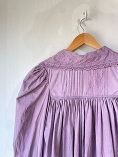 Vintage Victorian Overdyed Purple Dress. Lace-trimmed dress with bow details and puffy sleeves that make you feel like you're in a haunted 1920s mansion. The collar has black details that bring out the lacey designs. In good vintage condition with a few missing buttons (sold as is). Fits like a S/M. Feels like cotton/linen. Approx. Measurements: Underarm to underarm: 18" Length: 55" Cottagecore Lace Trim Sleep Dress, Lace Trim Dresses For Gatherings, Vintage Fitted Ruffle Nightgown, Vintage Fitted Nightgown With Ruffles, Fitted Vintage Nightgown With Ruffles, Daywear Dresses With Lace Trim And Peter Pan Collar, Vintage Dress With Lace Trim For Daywear, Vintage Prairie Dress With Gathered Sleeves, Long Sleeve Lace Collar Cottagecore Dress