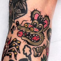 a close up of a person's foot with tattoos on it and an animal