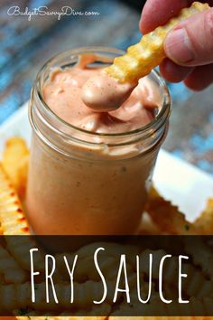 a person dipping some food into a small jar with the words fry sauce on it