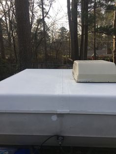 a mattress on top of a boat in the woods