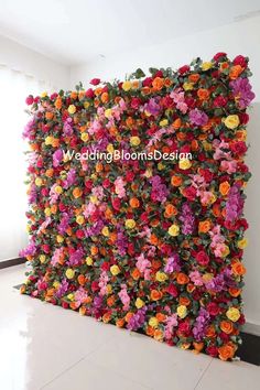 colorful flowers are arranged on the side of a wall