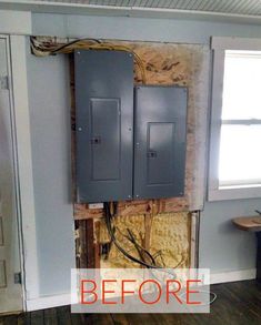 an electrical panel in the corner of a room that is under construction and being repaired