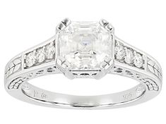 an antique style engagement ring set with a princess cut diamond in the center and side stones