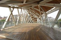 a wooden floor with white lines on the top and bottom, in front of some buildings