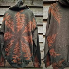 two pictures of the back and side of a hoodie with an orange fern print on it