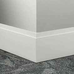 the corner of an empty room with carpeting on the floor and white walls in the background