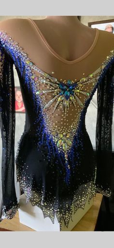 a black and blue top with sequins on it