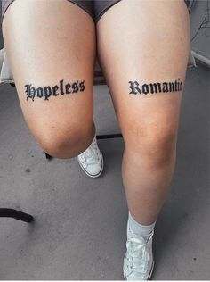 two people with tattoos on their legs that say homeless and romani in small letters