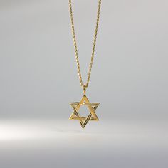 Fall in love with its captivating symmetry. This 14K solid gold handmade star of David pendant is a must-have for anyone who pays attention to even the smallest of details. A quick inspection of the piece will make you admire over the 30 years of experience we bring with every handcrafted pendant we make. This one is no exception as the edges, the points, and its overall appeal genuinely captures the aura of one of the most popular Jewish symbols. Send it as a gift or add it to your collection o Engraved Star-shaped Yellow Gold Necklace, Spiritual Yellow Gold Necklace With Star Charm, Engraved Star Yellow Gold Necklace, Gold Star-shaped Jewelry With Polished Finish, Gold Star Of David Jewelry For Anniversary, Gold Star Of David Necklace In 14k Gold, Yellow Gold Jewelry With Polished Finish, Star Of David, Gold Engraved Star Of David Necklace, Classic Star Shaped Necklace For Gift