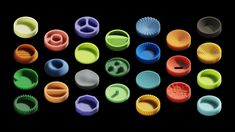 many different colored plastic objects on a black background