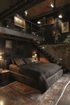 a large bed sitting under a staircase in a bedroom next to a table with two lamps on it