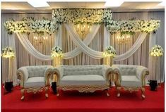 an elegant wedding setup with couches and flowers