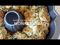 a pan filled with bread covered in cheese and herbs