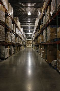 a large warehouse filled with lots of shelves and boxes on top of each shelf in front of the ceiling