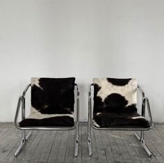 two black and white chairs sitting next to each other