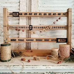 an old wooden frame with some twine and spools