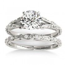 a white gold engagement ring set with an intricate filigreet design on the band