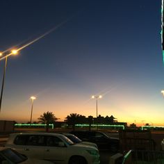 several cars parked in a parking lot at night