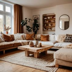 a living room filled with lots of furniture and decor on top of a wooden floor