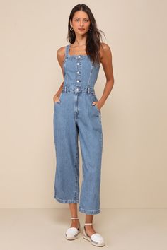 The Levi's Drea Medium Wash Button-Front Sleeveless Denim Jumpsuit is the one-and-done option for a totally coveted look! Sturdy cotton denim (in Levi's Cause and Effect wash) shapes wide, adjustable tank straps (with internal button closures at the back) and a straight neckline. The seamed bodice has a functional silver button placket that meets the high waist with belt loops. Loose-fitting, straight pant legs feature a hidden zip fly, diagonal front pockets, back patch pockets, and ankle-length hems. Smocking at back for fit. Classic red logo tag at back. Fit: This garment fits true to size. Length: Ankle length. Bust: Great for any cup size. Waist: Fitted - very fitted at natural waist. Hip: Loosely Fitted. Undergarments: May be worn with a strapless bra, adhesive bra, petals, or no bra Concert Outfit Casual, Wineries Outfit, Casual Formal Dresses, Jumpsuit Blue, Lulu Fashion, Silver Button, Adhesive Bra, Casual Wedding Dress, Cause And Effect