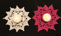 two small crocheted candles are next to each other