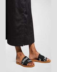 "Find CHLOÉ Woody Flat Logo Ribbon Slide Sandals on Editorialist. Chloe sandals with layered logo ribbon upper. 0.3\" flat heel. Open toe. Slideon style. Leather footbed. Rubber outsole. Imported." Chloe Sandals, Flat Logo, Ribbon Slides, Slide Sandals, Black Sandals, Open Toe, Chloe, Ribbon, Sandals