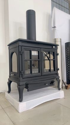 a black stove sitting on top of a white floor