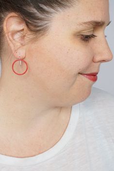 These lightweight circle earrings are sure to become your new favorite pair. An update on classic hoops, each circle retains evidence of their making - a small dot marks the spot where I hand-weld each earring. Approximately 1 1/4" tall (including ear wires) and 7/8" wide. Powder coated in a bright red color. Sterling silver ear wires. Handcrafted in my Pennsylvania studio. Ships in 1-2 business days. Comes in a gift box. Treat yourself or a loved one! Hypoallergenic Red Round Jewelry, Small Hoop Red Earrings For Everyday, Red Sterling Silver Hoop Earrings, Red Sterling Silver Round Hoop Earrings, Red Jewelry With Matching Earrings For Everyday, Minimalist Red Round Earrings, Nickel Free Red Hoop Earrings, Nickel-free Red Hoop Earrings, Adjustable Red Hoop Earrings