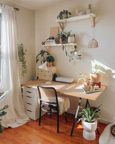 a room with a desk, chair and shelves filled with houseplants on the wall