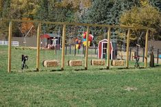 an outdoor play area with hay bales and children's toys