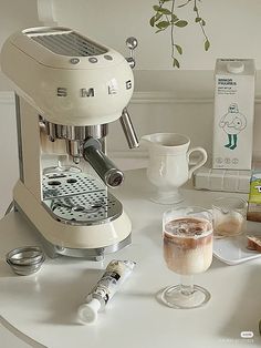 an espresso machine sitting on top of a white table