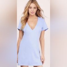 The Dress Features A Deep V-Neckline And Short Sleeves, With A Zip Closure For Easy Wear. The Dress Is Made Of A Blend Of 96% Polyester And 4% Spandex, Making It Lightweight And Comfortable. Flat Lay Measurements Pit To Pit: 18.5" Vee Neck Drop: 10" Sleeve Length: 7" Length: 32" Blue V-neck Beach Dress For Spring, Blue V-neck Dress For Brunch, Blue V-neck Dress, Chic Blue Dress With Notched Neckline, Blue Dresses With Notched Neckline, Light Blue V-neck Mini Dress For Brunch, Blue V-neck Mini Dress, Chic Blue V-neck Beach Dress, Blue V-neck Dress For Spring Date Night