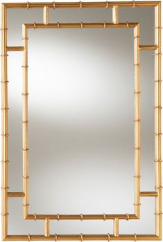 a mirror that is sitting on top of a white wall next to a wooden frame