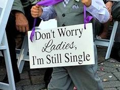 a little boy holding a sign that says don't worry ladies, i'm still single