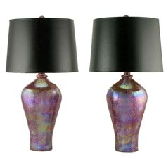 two purple lamps with black shades on them