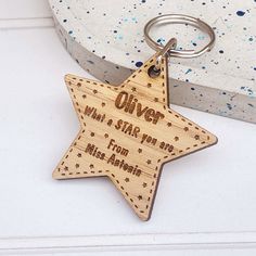 a wooden keychain with an engraved star on the front and back, which reads'what a star you are from miss always '