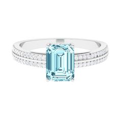 an emerald and diamond ring on a white background