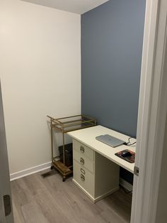 an empty room with a desk and computer on it