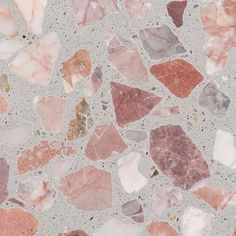 a close up of a tile with many different colored rocks on it's surface