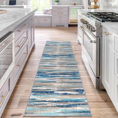 a blue runner rug in a white kitchen