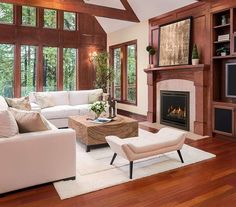 a living room filled with furniture and a flat screen tv mounted on the wall above a fireplace