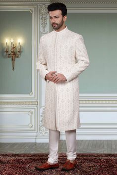 This Mens Sherwani (R14-S94) is the perfect attire for any groom with its beautifully crafted thread embroidery and stone embellishments. The intricate detailing adds a touch of elegance to this traditional garment. Its timeless design will make you stand out on your special day. Traditional Naqshi Kurta For Reception, Bollywood Sherwani With Intricate Embroidery For Groom, Elegant Groom's Nehru Jacket With Dabka Work, Groom's Transitional Sherwani With Chikankari Embroidery, Elegant Traditional Wear With Naqshi In Traditional Drape, Elegant Traditional Wear With Naqshi Drape, Elegant Traditional Wear With Naqshi, Bollywood Bandhgala With Chikankari Embroidery For Groom, Groom's Sherwani With Intricate Embroidery