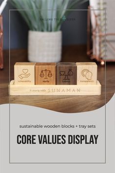 three wooden blocks with the words core value display on them in front of a potted plant