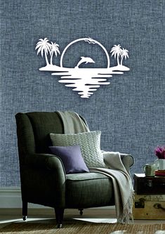 a living room with a chair and wall decal in the shape of palm trees