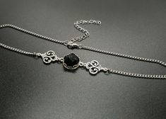 "Delicate victorian style choker featuring a genuine onyx stone sitting in an ornate bezel setting. The middle piece is set inbetween two beautifully detailed ornate connectors. The choker works fine on its own or stacked with another necklace. The chain is made of long lasting stainless steel and other components of high quality silver plated metal.  Stone:  12mm diameter Please choose your length in the drop down menu. Length = chain length including the clasp. Comes with an additional strong Victorian Metal Choker Necklace, Victorian Style Metal Choker Necklace, Elegant Black Necklaces With Oxidized Finish, Elegant Black Necklace With Oxidized Finish, Gothic Sterling Silver Choker Necklace, Gothic Silver Choker With Adjustable Chain, Black Vintage Oxidized Jewelry, Elegant Metal Choker With Oxidized Finish, Vintage Oxidized Black Jewelry